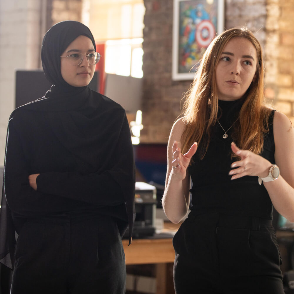 Two women in a group conversation