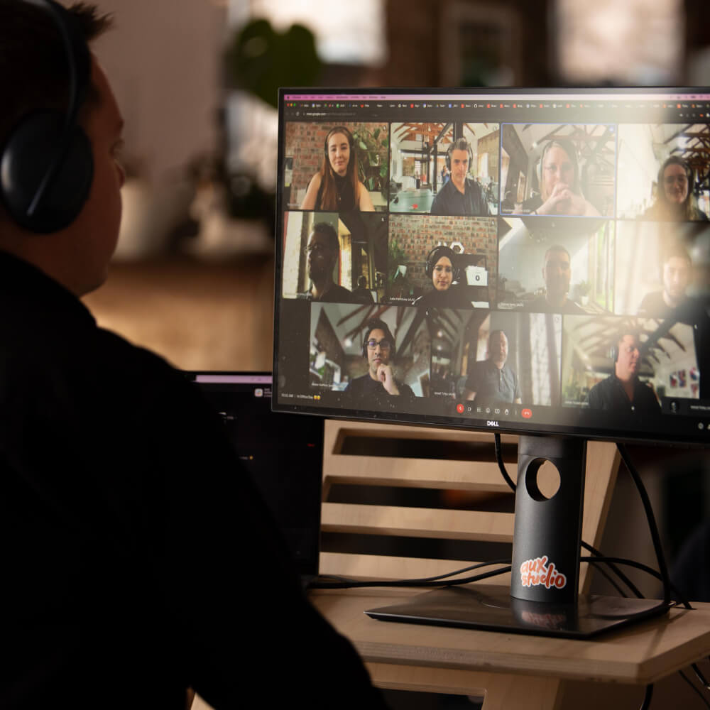 A person in a Google Meeting with various people on the screen
